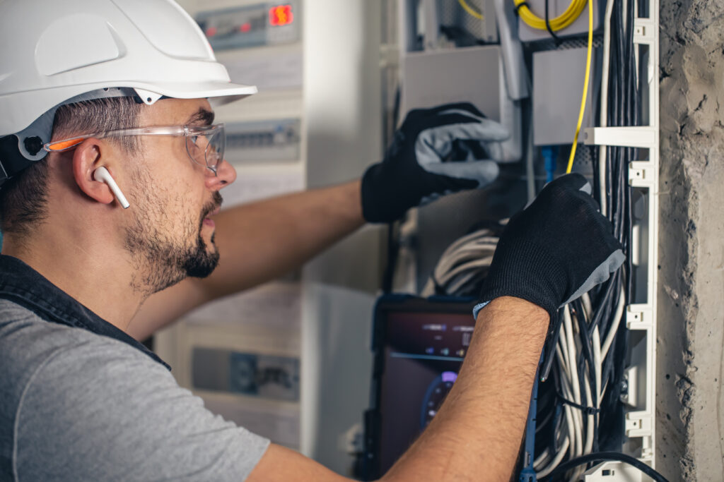 Professional electrician working with fuses.