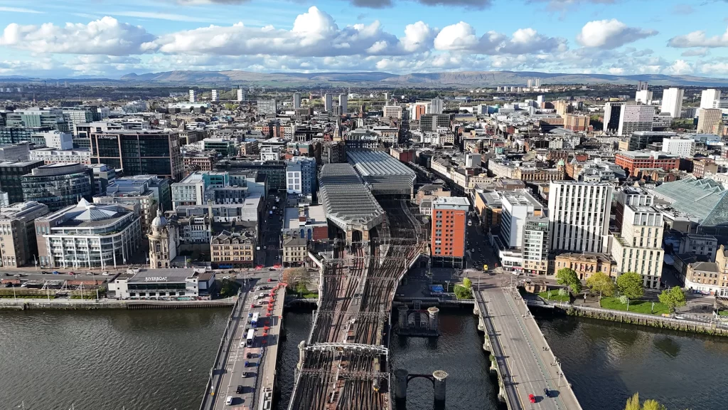 Aerial drone view of Glasgow cityscape, highlighting the urban landscape and opportunities for electrician jobs in Glasgow.