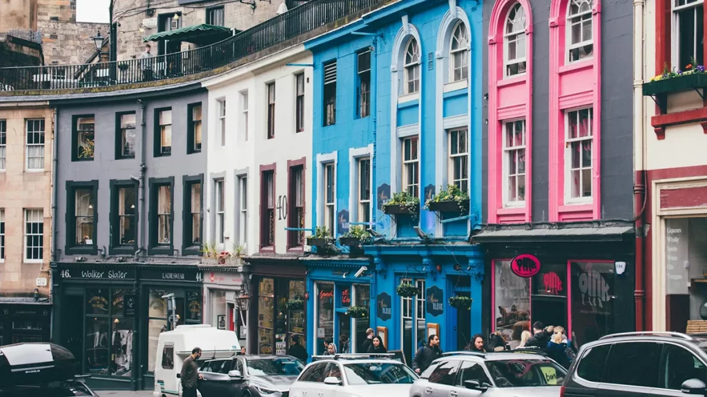 Colorful shopfronts and historic buildings lining the curved cobblestone Victoria Street in Edinburgh, a vibrant backdrop for promoting opportunities in Mechanical Fitter Jobs Edinburgh.